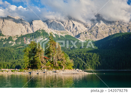 Forest island in Eibsee lake under Zugspitze mountain Bavaria Germany 142079276