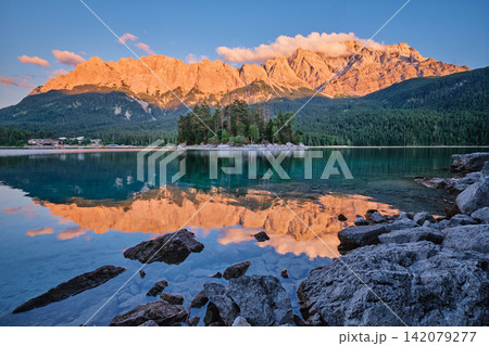 Sunset reflections of Zugspitze mountain in Eibsee alpine lake Germany Sunset reflections of Zugspitze mountain in Eibsee alpine lake Germany 142079277