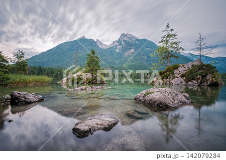 Long exposure of Hintersee lake with moving clouds and Hoher Goll peaks Long exposure of Hintersee lake with moving clouds and Hoher Goll peaks 142079284