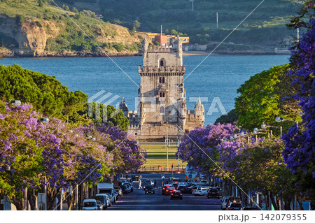 Breathtaking view of Belem Tower in Lisbon framed by blooming jacaranda trees Breathtaking view of Belem Tower in Lisbon framed by blooming jacaranda trees 142079355