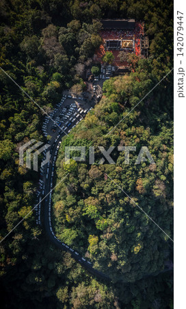 Mountain parking lot surrounded by dense forest at Doi Tung, Chiang Rai, serving visitors to Phra That Doi Tung in 2023. Mountain parking lot surrounded by dense forest at Doi Tung, Chiang Rai, serving visitors to Phra That Doi Tung in 2023. 142079447