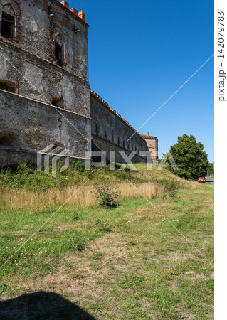 Long historic stone wall and palace tower of Medzhybizh fortress in Ukraine Long historic stone wall and palace tower of Medzhybizh fortress in Ukraine 142079783