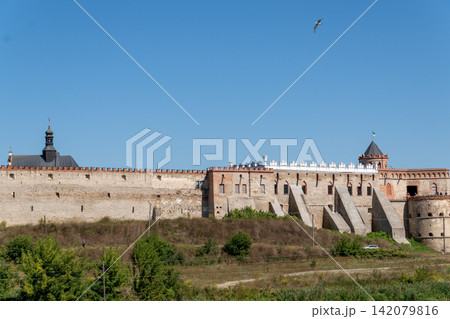 Panoramic view of ancient medieval castle with long fortification stone walls 142079816