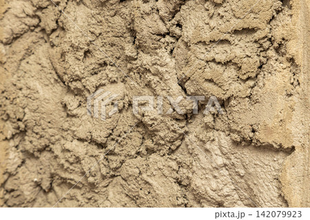 Close-Up of Rough Wet Plaster Texture Background Close-Up of Rough Wet Plaster Texture Background 142079923