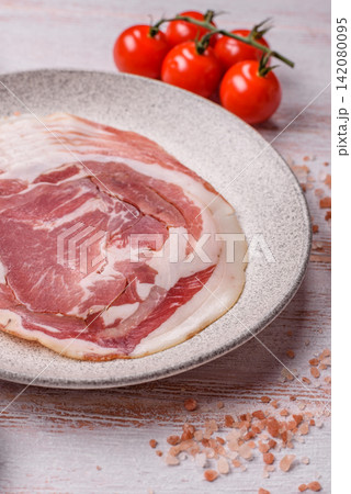 Slices of pork pancetta, ham, or bacon for a festive antipasto platter 142080095