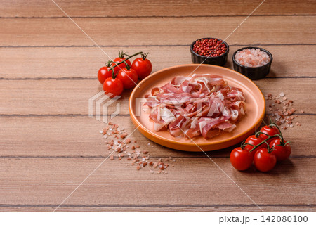 Slices of pork pancetta, ham, or bacon for a festive antipasto platter Slices of pork pancetta, ham, or bacon for a festive antipasto platter 142080100