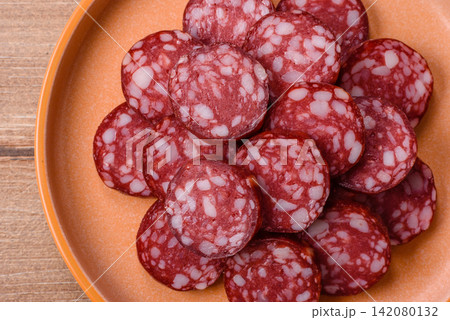 Slices of smoked salami for sandwiches or a lunch spread. Salami slices Slices of smoked salami for sandwiches or a lunch spread. Salami slices 142080132