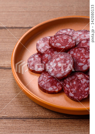 Slices of smoked salami for sandwiches or a lunch spread. Salami slices Slices of smoked salami for sandwiches or a lunch spread. Salami slices 142080133