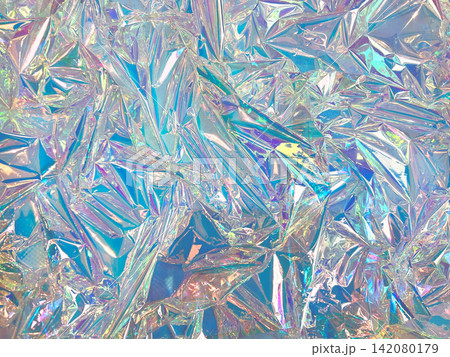 Crumpled iridescent holographic foil surface with prismatic rainbow color shift and crystal facet texture Crumpled iridescent holographic foil surface with prismatic rainbow color shift and crystal facet texture 142080179