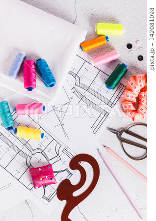 Sewing patterns for self-tailoring on a tailor's workbench top and vertical view 142081098