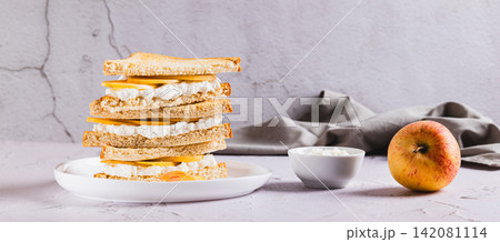 Fresh apples and feta cheese in triangular toasts on a plate on the table web banner Fresh apples and feta cheese in triangular toasts on a plate on the table web banner 142081114