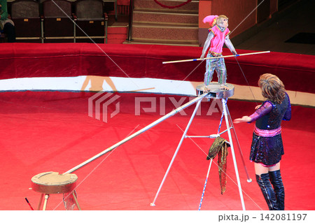 Trained monkey walking on rope with balance beam in Gomel circus 142081197