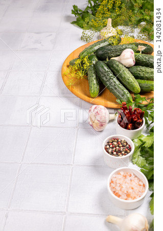 Preparing fresh cucumbers and ingredients for pickling process Preparing fresh cucumbers and ingredients for pickling process 142081434
