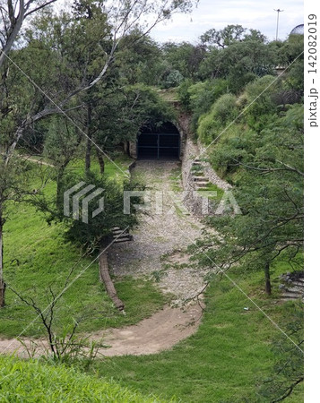 Gated brick arch tunnel entrance in a green ravine at Sarmiento Park Gated brick arch tunnel entrance in a green ravine at Sarmiento Park 142082019