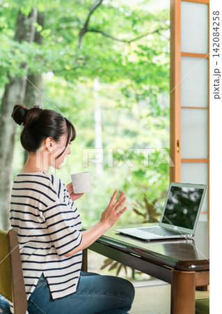 テレビ電話,ビデオ通話をするワーケーション,リモートワークをするアジア人女性 テレビ電話,ビデオ通話をするワーケーション,リモートワークをするアジア人女性 142084258