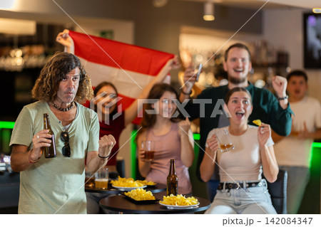Group of fans in bar with Austrian flag Group of fans in bar with Austrian flag 142084347
