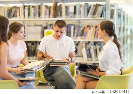 Students sit in circle in library 142084412