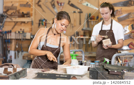 Guy is busy in carpentry workshop with female entrepreneur 142084552