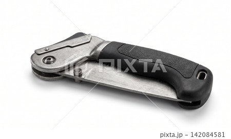 Compact folding pocket saw with ergonomic black handle on white surface woodworking carpentry survival equipment hardware portable mechanism textured ergonomic construction industrial 142084581