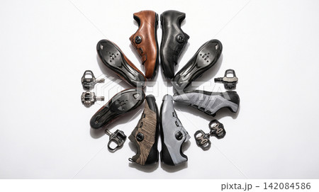 Circular arrangement of professional cycling shoes and metal pedal cleats displayed on clean white background with footwear accessories circular arrangement background synthetic fastening Circular arrangement of professional cycling shoes and metal pedal cleats displayed on clean white background with footwear accessories circular arrangement background synthetic fastening 142084586