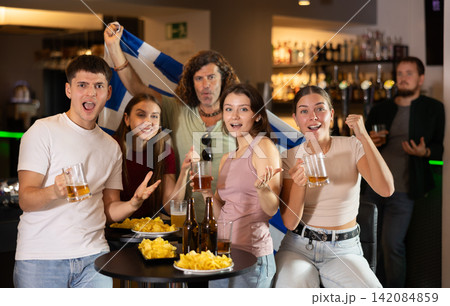 Group of fans in bar with Greek flag Group of fans in bar with Greek flag 142084859