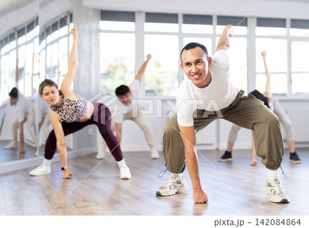 Young Asian man practicing modern street dance in studio Young Asian man practicing modern street dance in studio 142084864