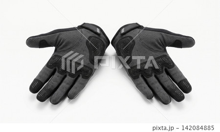 Pair of dark grey cycling gloves with padded palms isolated protection accessory clothing breathable ergonomic recreation exercise stitching isolated background Pair of dark grey cycling gloves with padded palms isolated protection accessory clothing breathable ergonomic recreation exercise stitching isolated background 142084885