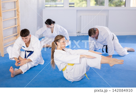 Young female karate practitioner training blocks lying in press position 142084910