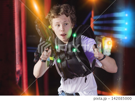 Young guy playing lasertag in arena Young guy playing lasertag in arena 142085000