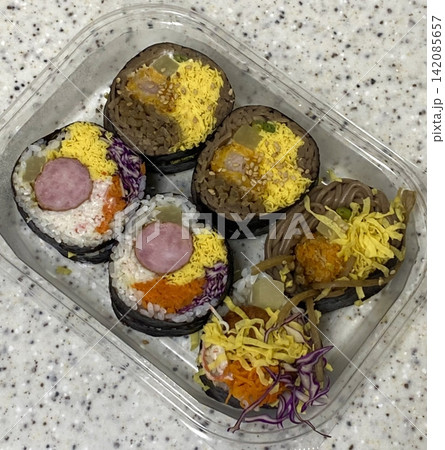 Fresh kimbap rolls filled with rice, vegetables, and savory ingredients, neatly wrapped in seaweed. Colorful, balanced, and satisfying, offering a classic Korean flavor with a clean, appetizing look. Fresh kimbap rolls filled with rice, vegetables, and savory ingredients, neatly wrapped in seaweed. Colorful, balanced, and satisfying, offering a classic Korean flavor with a clean, appetizing look. 142085657