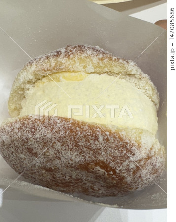 Bomboloni, soft Italian doughnuts filled with creamy custard or jam, dusted with powdered sugar. Fluffy and indulgent, they’re a perfect sweet treat, enjoyed fresh and warm with every bite. 142085686