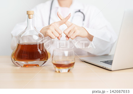 Doctor hand stop to refuse Whisky, quitting drink for healthy liver, prevent Alcoholic cirrhosis and cancer, World No Alcohol Day, medical advice for sobriety and Alcoholism and addiction concept Doctor hand stop to refuse Whisky, quitting drink for healthy liver, prevent Alcoholic cirrhosis and cancer, World No Alcohol Day, medical advice for sobriety and Alcoholism and addiction concept 142087033
