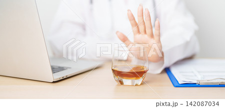 Doctor hand stop to refuse Whisky, quitting drink for healthy liver, prevent Alcoholic cirrhosis and cancer, World No Alcohol Day, medical advice for sobriety and Alcoholism and addiction concept Doctor hand stop to refuse Whisky, quitting drink for healthy liver, prevent Alcoholic cirrhosis and cancer, World No Alcohol Day, medical advice for sobriety and Alcoholism and addiction concept 142087034