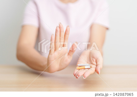 woman hand break cigarette for World No Tobacco Day concept, quitting smoking to prevent Lung Cancer, COPD, Emphysema and Tuberculosis disease. healthy lifestyle resolution, stop nicotine addiction woman hand break cigarette for World No Tobacco Day concept, quitting smoking to prevent Lung Cancer, COPD, Emphysema and Tuberculosis disease. healthy lifestyle resolution, stop nicotine addiction 142087065