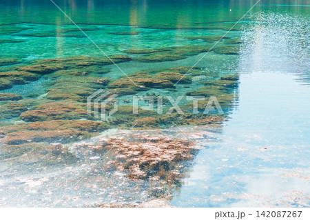 Scenery Jiuzhaigou national park in Sichuan, China. Beautiful Five Flower Lake in Autumn season. Famous Landmark and Vacation near Chengdu, China. Asia travel concept Scenery Jiuzhaigou national park in Sichuan, China. Beautiful Five Flower Lake in Autumn season. Famous Landmark and Vacation near Chengdu, China. Asia travel concept 142087267