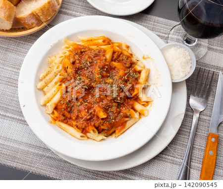 Pasta bolognese with cheese served on platter Pasta bolognese with cheese served on platter 142090545