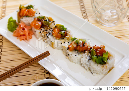 Saketaki roll served with soya sauce and wasabi in a plate Saketaki roll served with soya sauce and wasabi in a plate 142090625