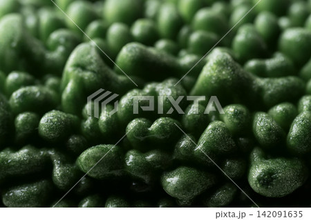 Close-up of fresh green bitter gourd or bitter melon texture background 142091635