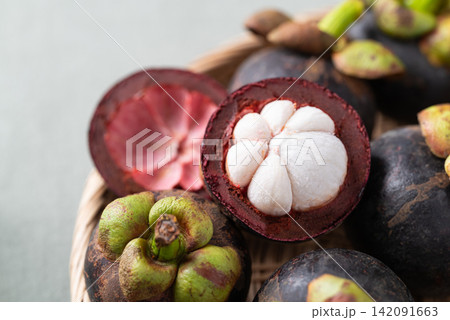 Close-up of fresh mangosteen in wicker basket, Tropical fruit in Thailand Close-up of fresh mangosteen in wicker basket, Tropical fruit in Thailand 142091663