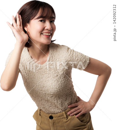 Happy cheerful asian woman listening closely holding hand near ear smiling curious isolated portrait posing joyful indoor background 142092312