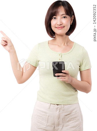 Happy young asian woman holding smartphone and pointing finger upward showing empty copy space against transparency background 142092352