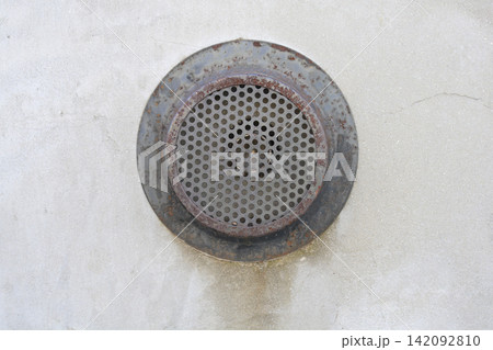 Old rusty metal ventilation grate on a concrete wall Old rusty metal ventilation grate on a concrete wall 142092810