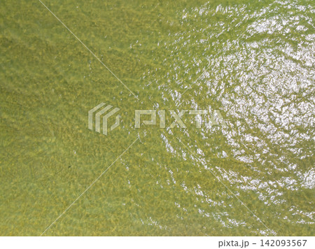 Bird eye view photo of sea beach water surface texture background Bird eye view photo of sea beach water surface texture background 142093567
