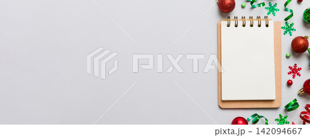 Christmas blank greeting card mock-up scene. Creative layout made of Christmas tree branches and paper card note. Flat lay. Nature New Year concept Christmas blank greeting card mock-up scene. Creative layout made of Christmas tree branches and paper card note. Flat lay. Nature New Year concept 142094667