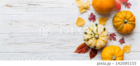 Autumn composition. Pattern made of dried leaves and other design accessories on table. Flat lay, top view Autumn composition. Pattern made of dried leaves and other design accessories on table. Flat lay, top view 142095155