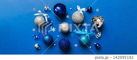 Christmas ball on colored background. decoration bauble with ribbon bow with copy space Christmas ball on colored background. decoration bauble with ribbon bow with copy space 142095182