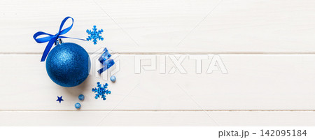 Christmas ball on colored background. decoration bauble with ribbon bow with copy space Christmas ball on colored background. decoration bauble with ribbon bow with copy space 142095184