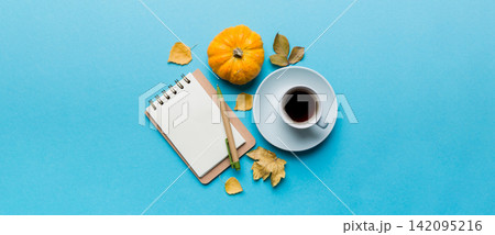 Autumn composition: fallen leaves and notebook mock up on colored background. Top view. Flat lay with copy space 142095216
