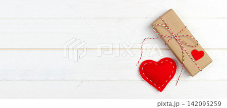 Gift box with fabric hearts on Black wooden table 142095259