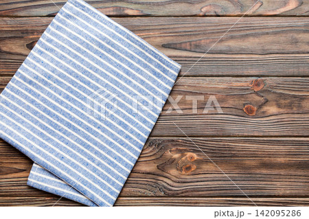 top view with blue kitchen napkin isolated on table background. Folded cloth for mockup with copy space, Flat lay. Minimal style 142095286